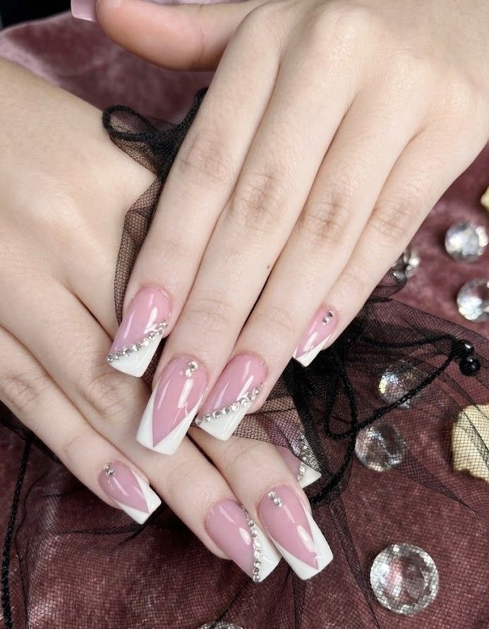 Pink French tip coffin nails with crystal accents